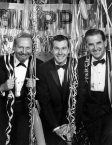 Publicity photo of the cast of the television program The Tonight Show as it prepared to celebrate 1963 with its new host, Johnny Carson. From left: bandleader Skitch Henderson, Johnny Carson and Ed McMahon.